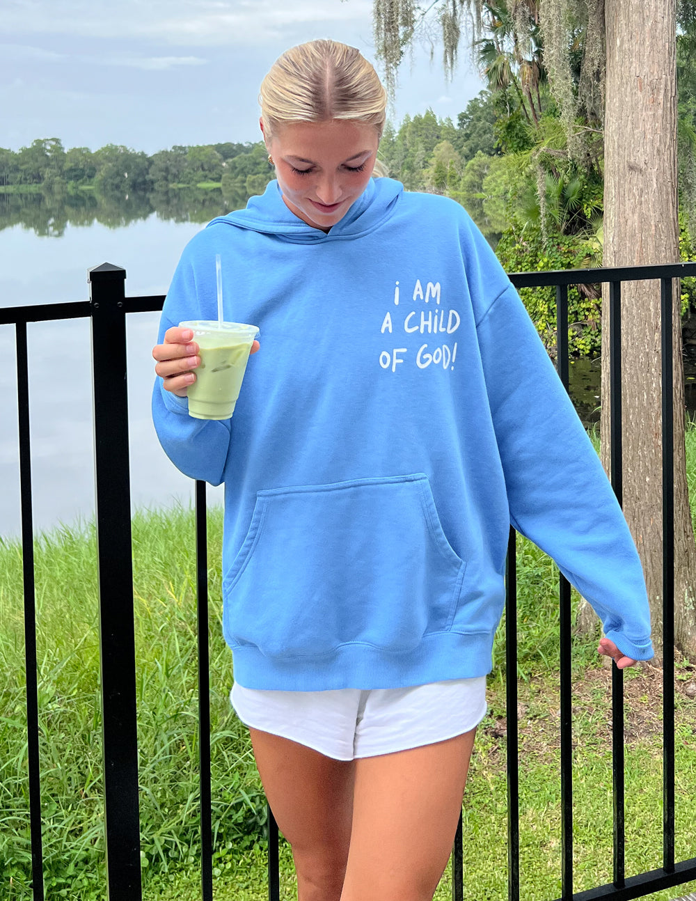 Light blue unisex hoodie with chest graphic and front pouch pocket