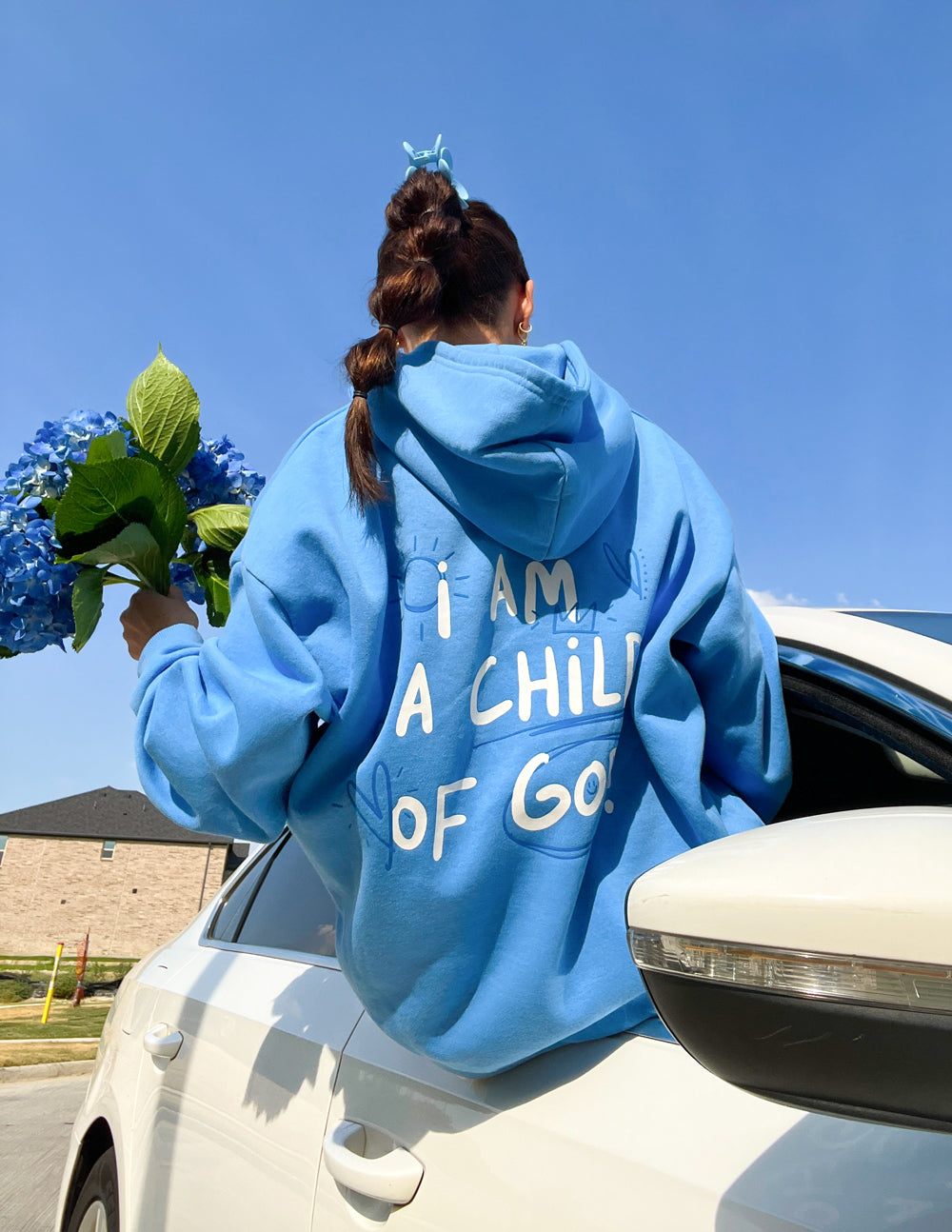 Light blue unisex hoodie, back graphic with raised hood
