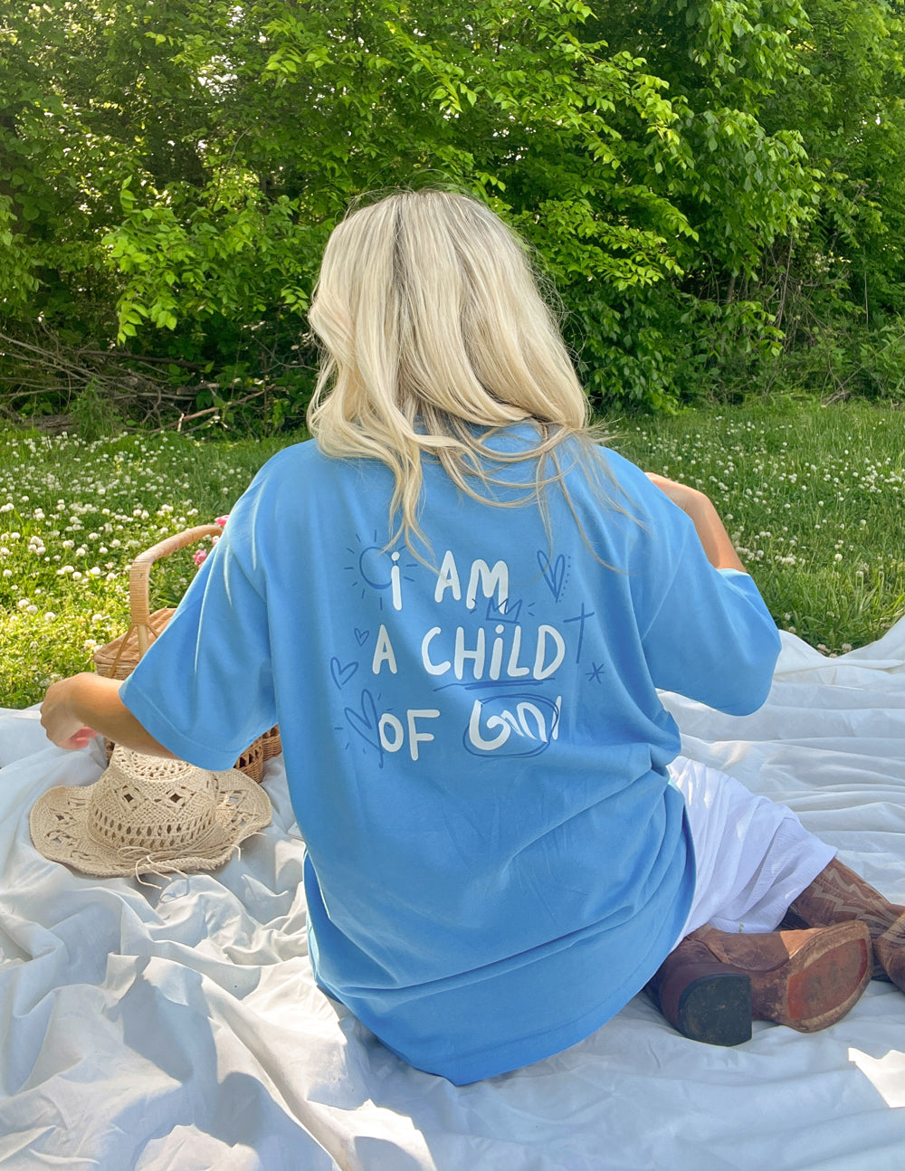 Blue unisex T-shirt viewed from back with “I AM A CHILD OF GOD!” text