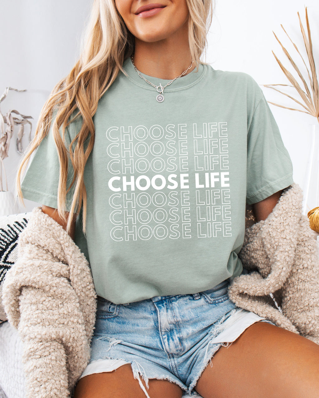 Sage green Christian t-shirt with “CHOOSE LIFE” text graphic on the front.