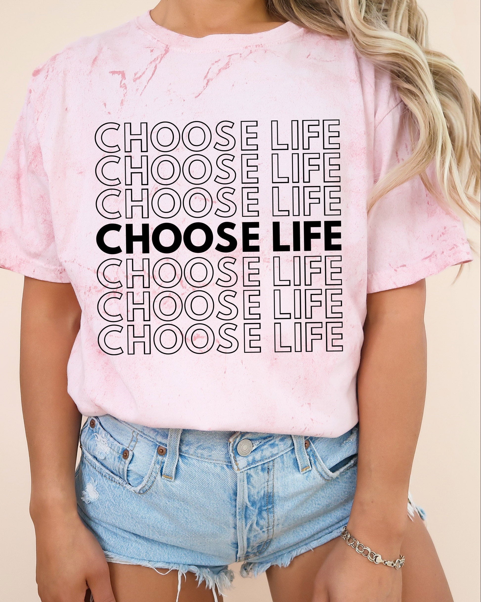 Light pink Christian t-shirt with “CHOOSE LIFE” text graphic on the front.