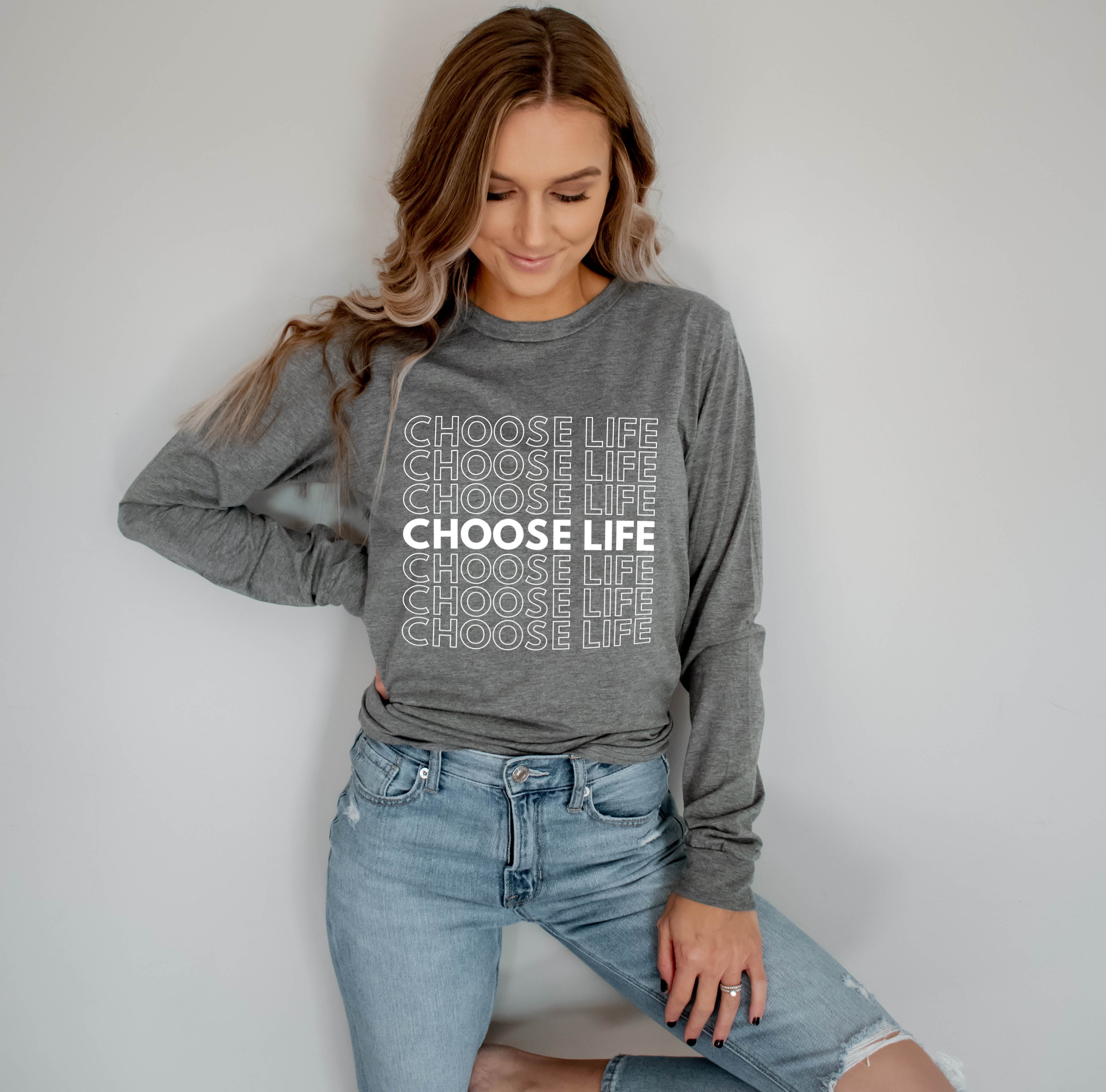 Long-sleeve T-shirt, heather gray with repeated slogan print, worn by model