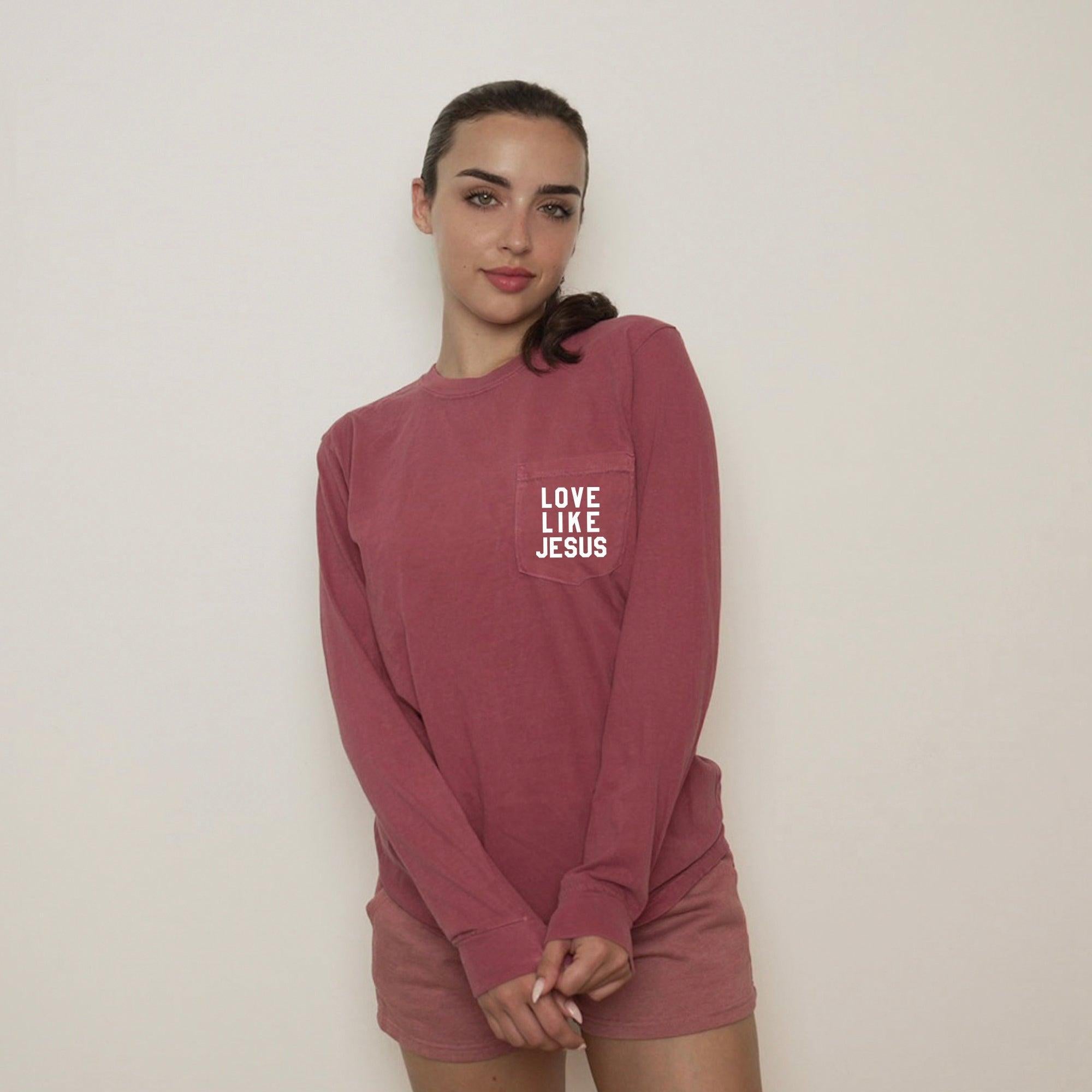 Maroon long sleeve pocket tee with "LOVE LIKE JESUS" chest print