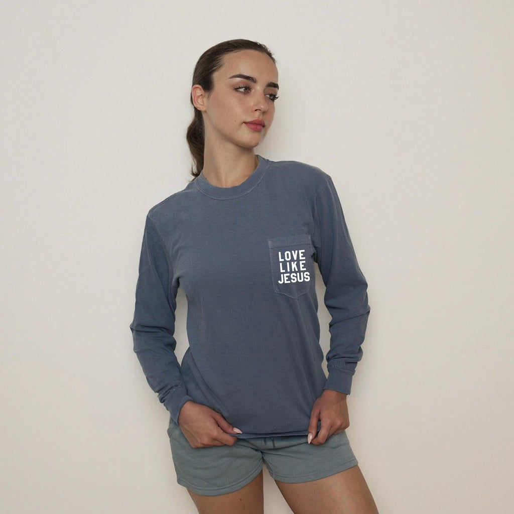 Blue long sleeve pocket tee with "LOVE LIKE JESUS" chest print