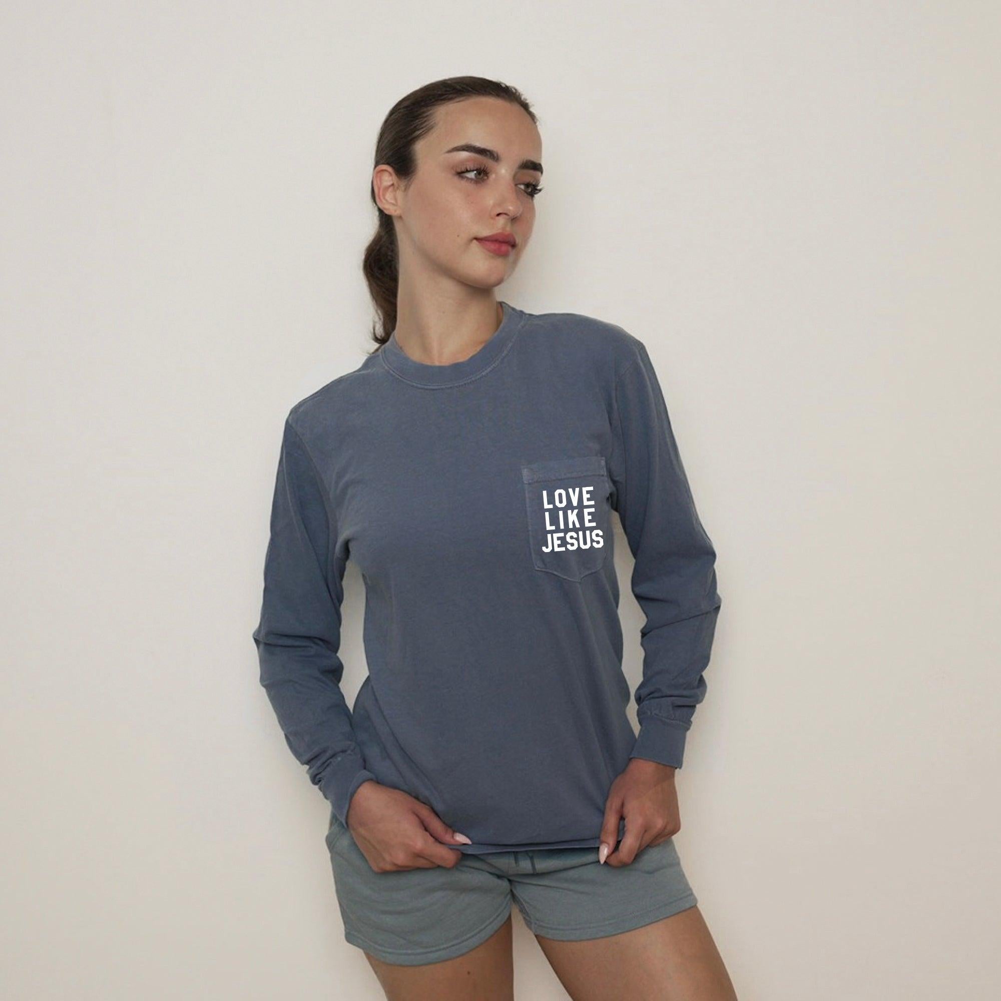 Blue long sleeve pocket tee with "LOVE LIKE JESUS" chest print