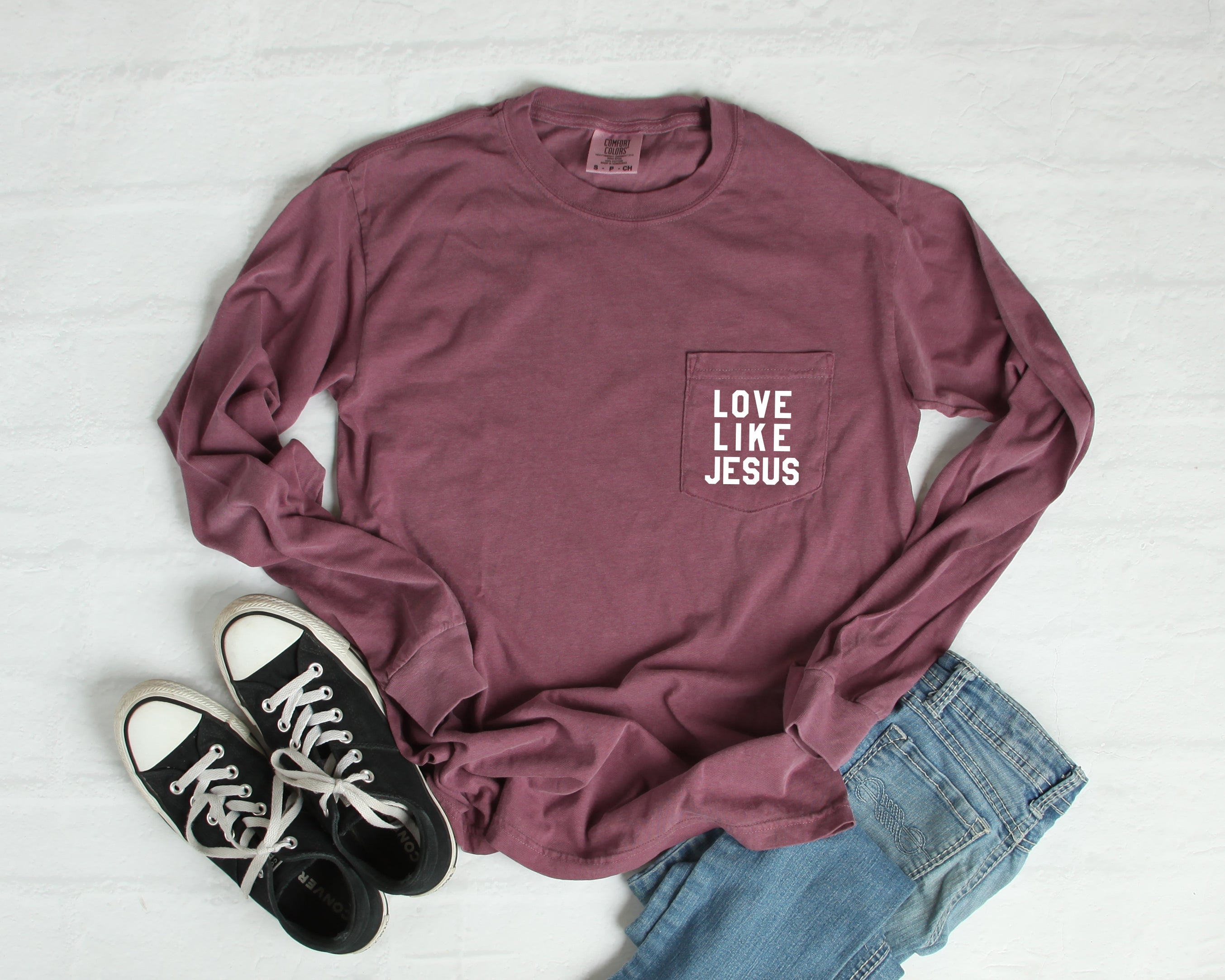 Maroon long sleeve pocket tee with front "LOVE LIKE JESUS" print