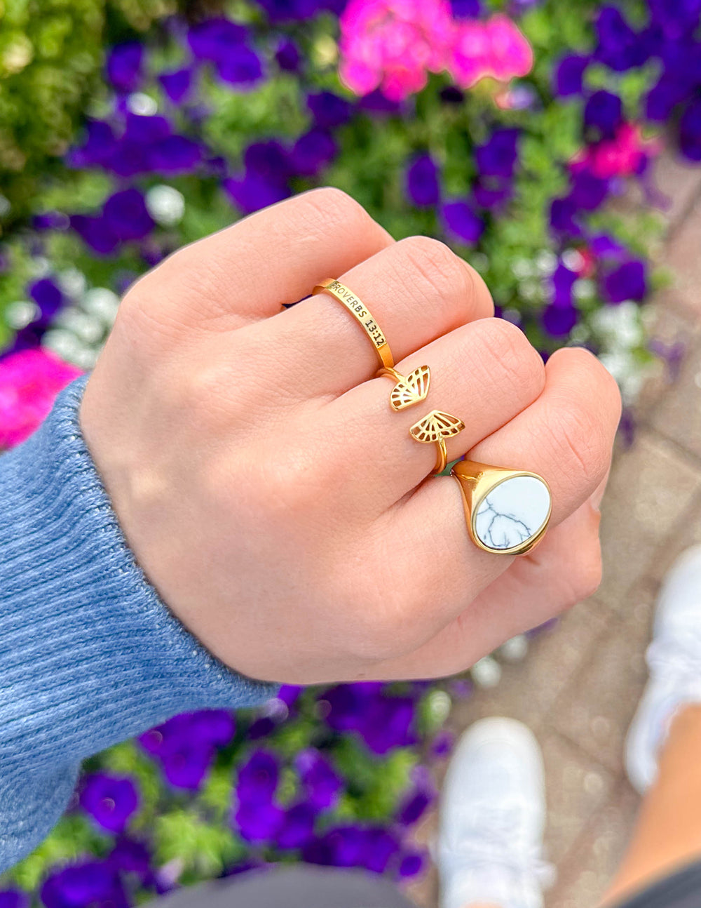 Gold-tone ring with small hanging charm; engraved band