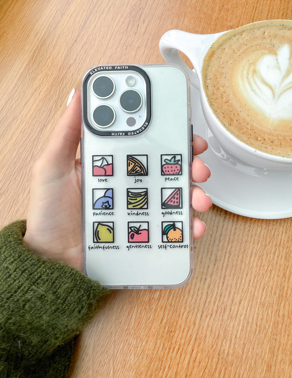Clear phone case with fruit-themed squares for love, joy, peace, and more