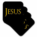 Set of black coasters with yellow 'JESUS' lettering and decorative accents