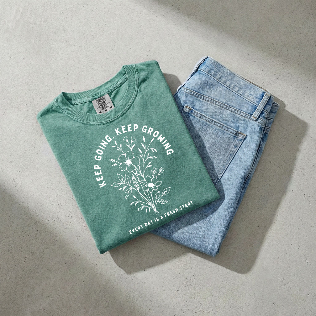 Green unisex T-shirt with botanical floral front graphic and crew neck.