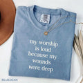Blue short-sleeve T-shirt with V-neck and necklace; front word graphic in light print