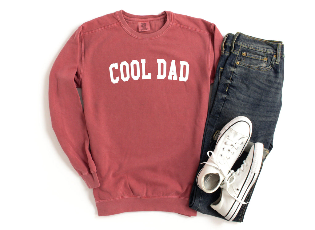 Red crewneck sweatshirt with white “COOL DAD” print