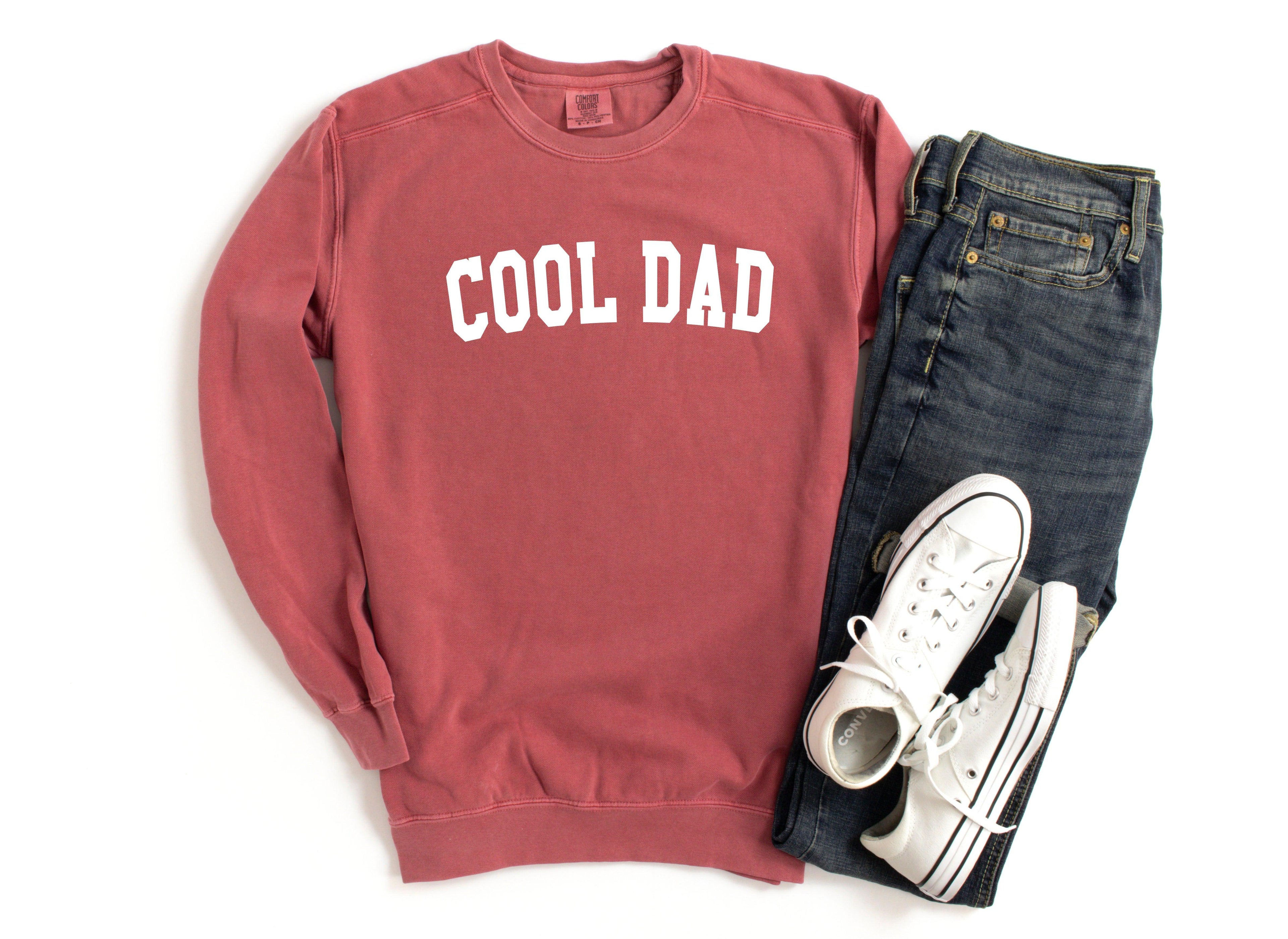 Red crewneck sweatshirt with white “COOL DAD” print