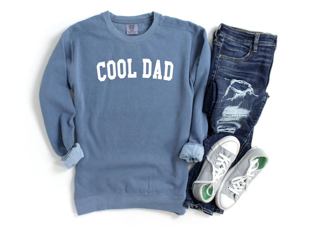 Blue crewneck sweatshirt with white “COOL DAD” print