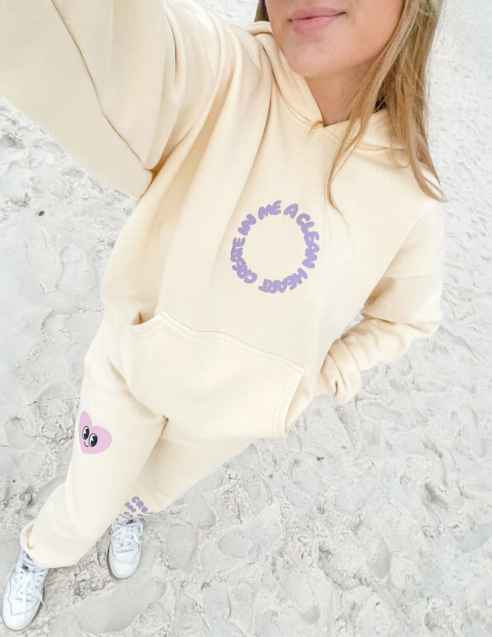 Unisex cream hoodie with purple chest graphic and purple sleeve print