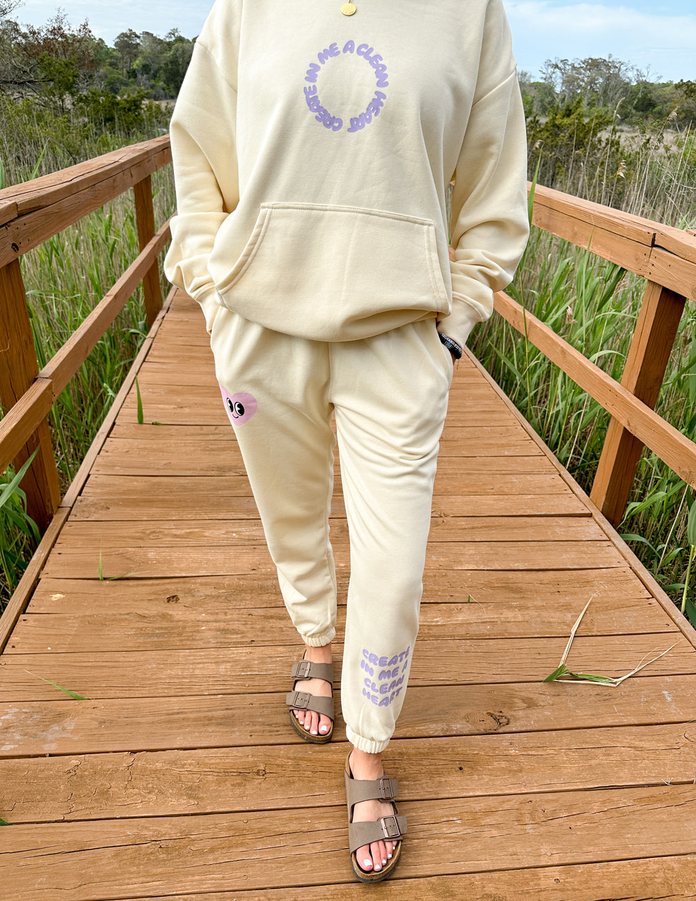 Cream unisex sweatpants with purple heart graphic and cuffed ankle hem
