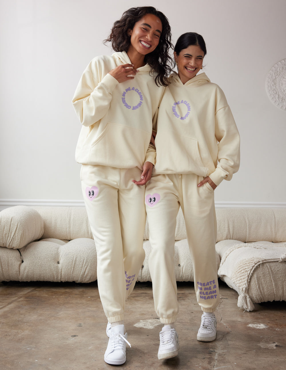 Cream unisex sweatpants with purple heart logos, tapered jogger fit and cuffs