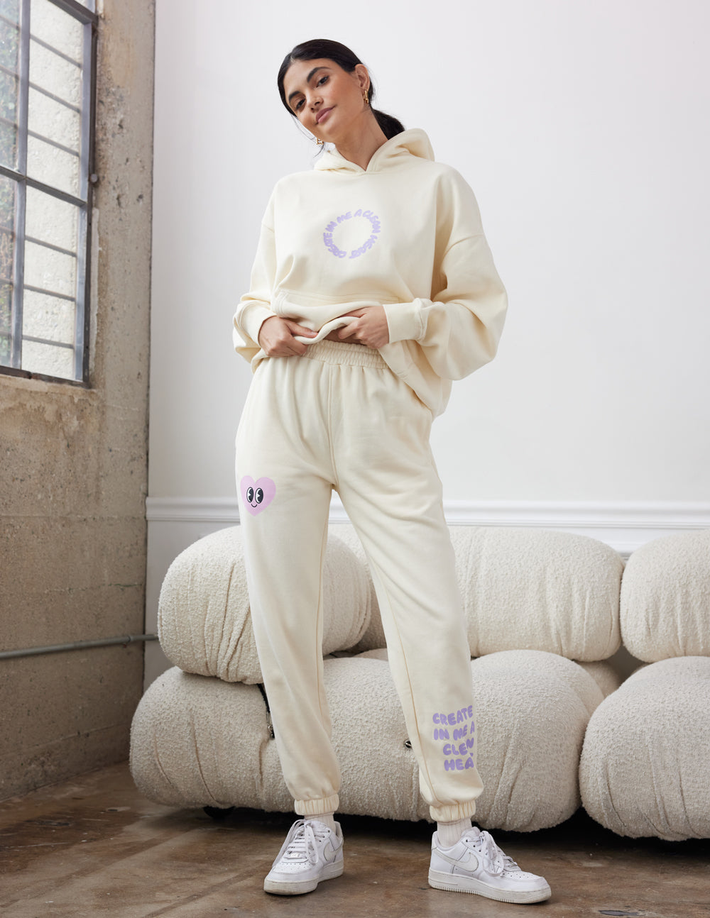 Cream unisex sweatpants with purple heart graphic on leg, elastic cuffed jogger