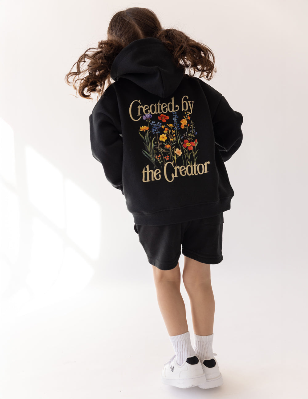 Kids black hoodie with floral “Created by the Creator” graphic on back