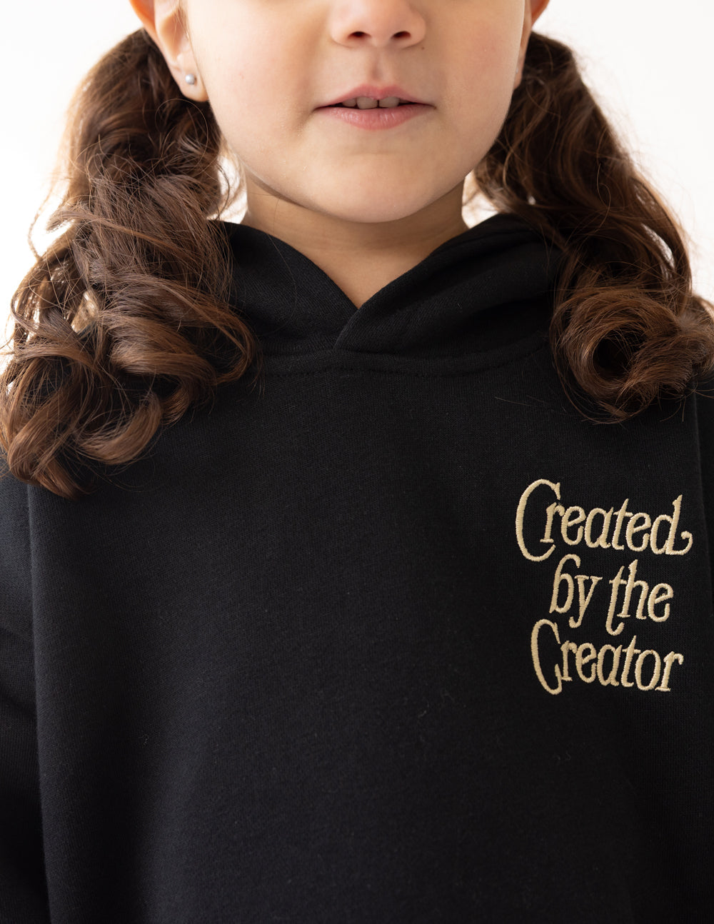 Kids black hoodie with front chest “Created by the Creator” text graphic