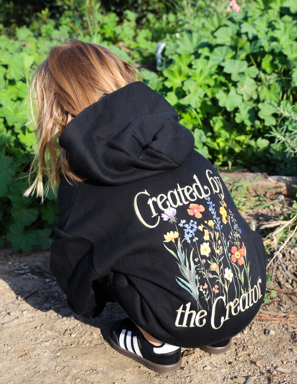 Kids black hoodie back with floral “Created by the Creator” graphic