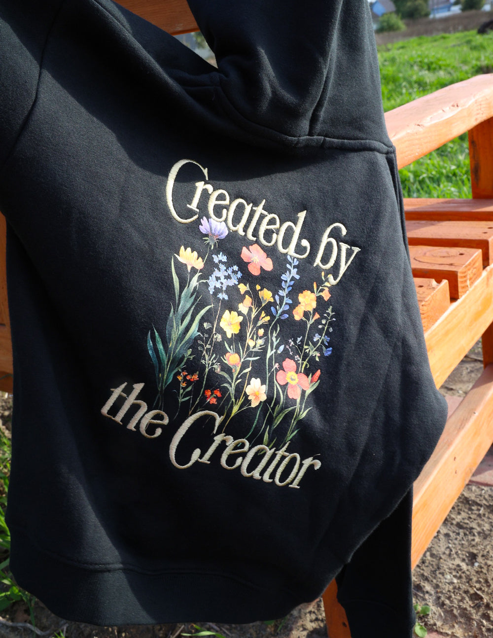 Kids black hoodie back with gold floral “Created by the Creator” print