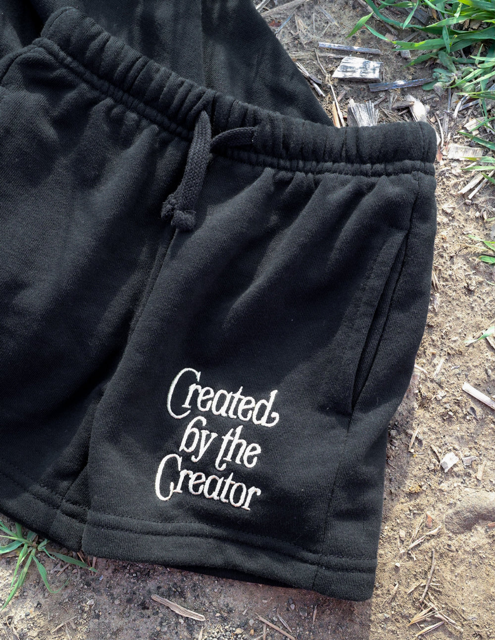 Kids dark shorts close-up with drawstring waist and Created by the Creator logo