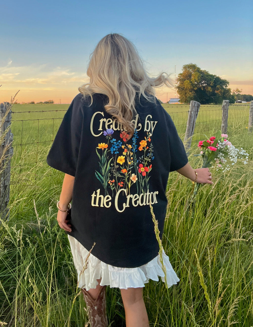 Black unisex tee with full back graphic text and colorful flower bouquet