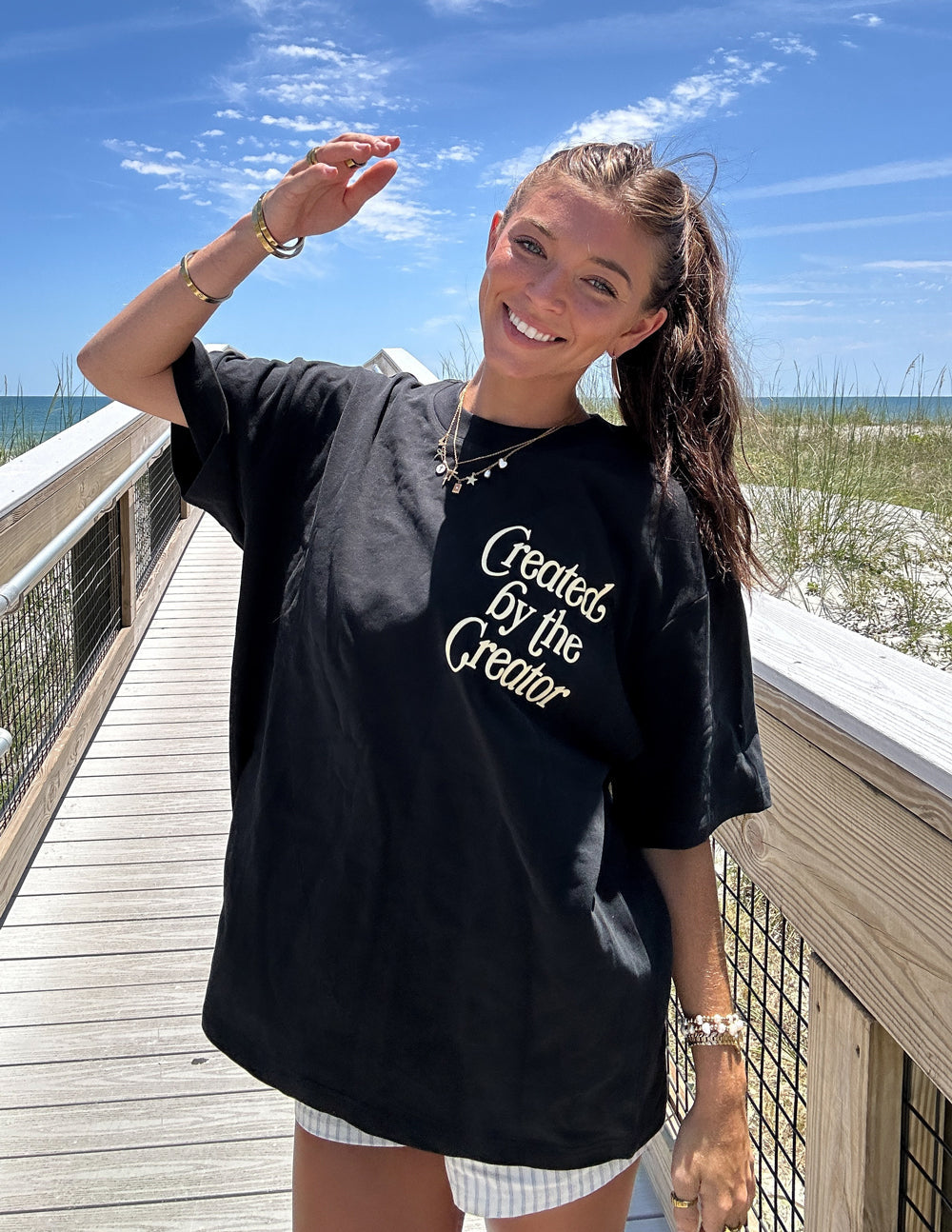 Black unisex tee with front graphic text and colorful floral design