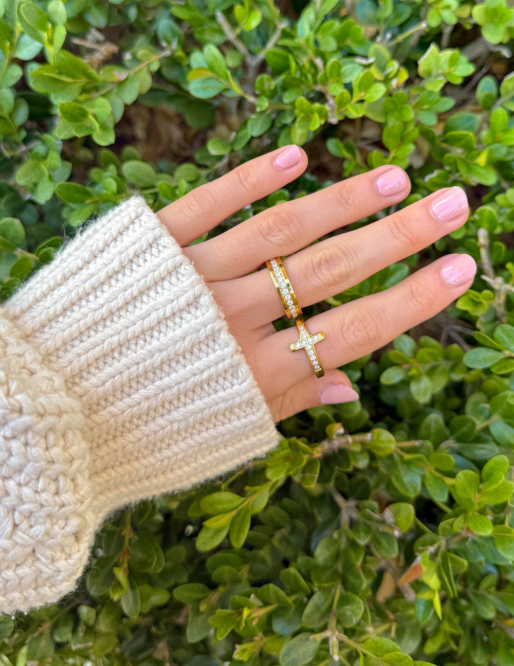 Gold cross ring with clear stone accents and a slim stacked band