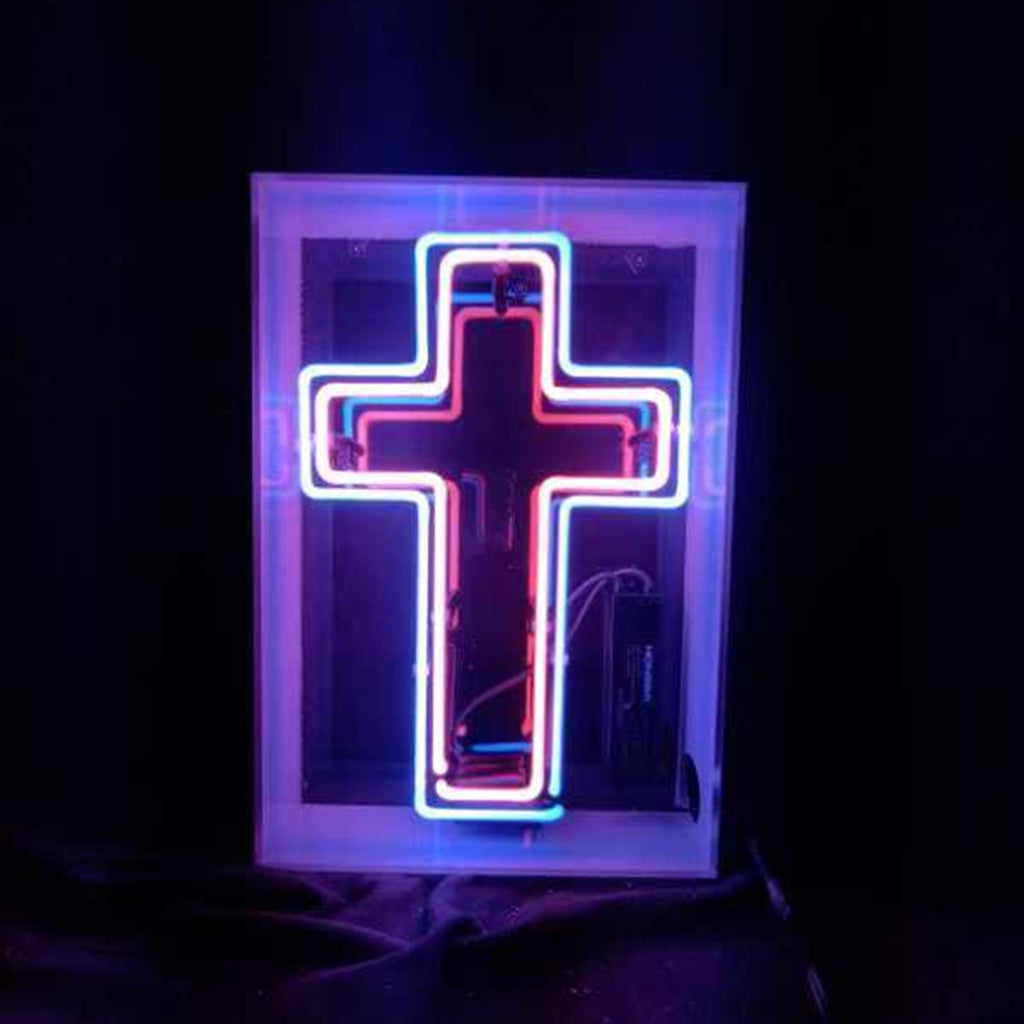 Cross neon sign in acrylic box with bright blue-purple glow
