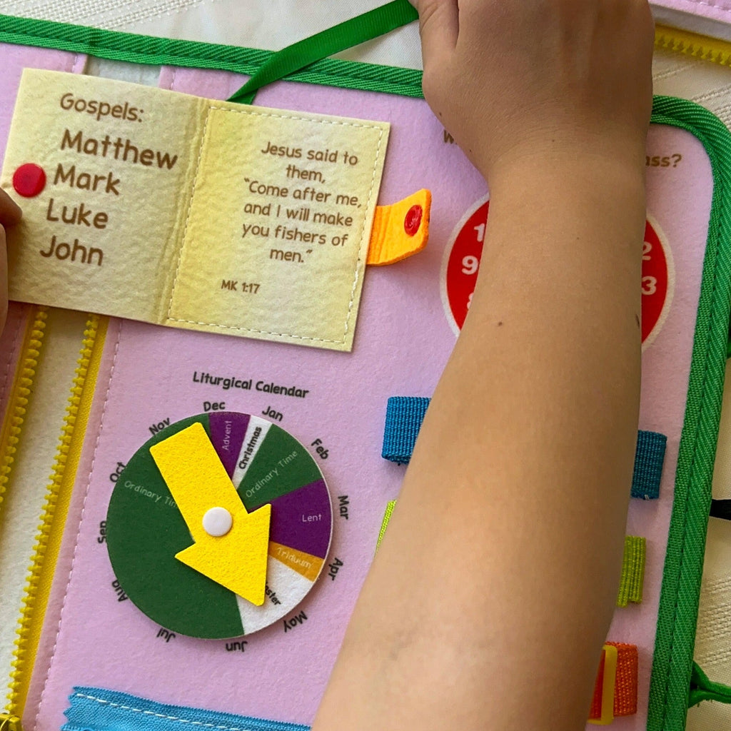 Felt busy book page showing Gospel tabs for Matthew, Mark, Luke, and John