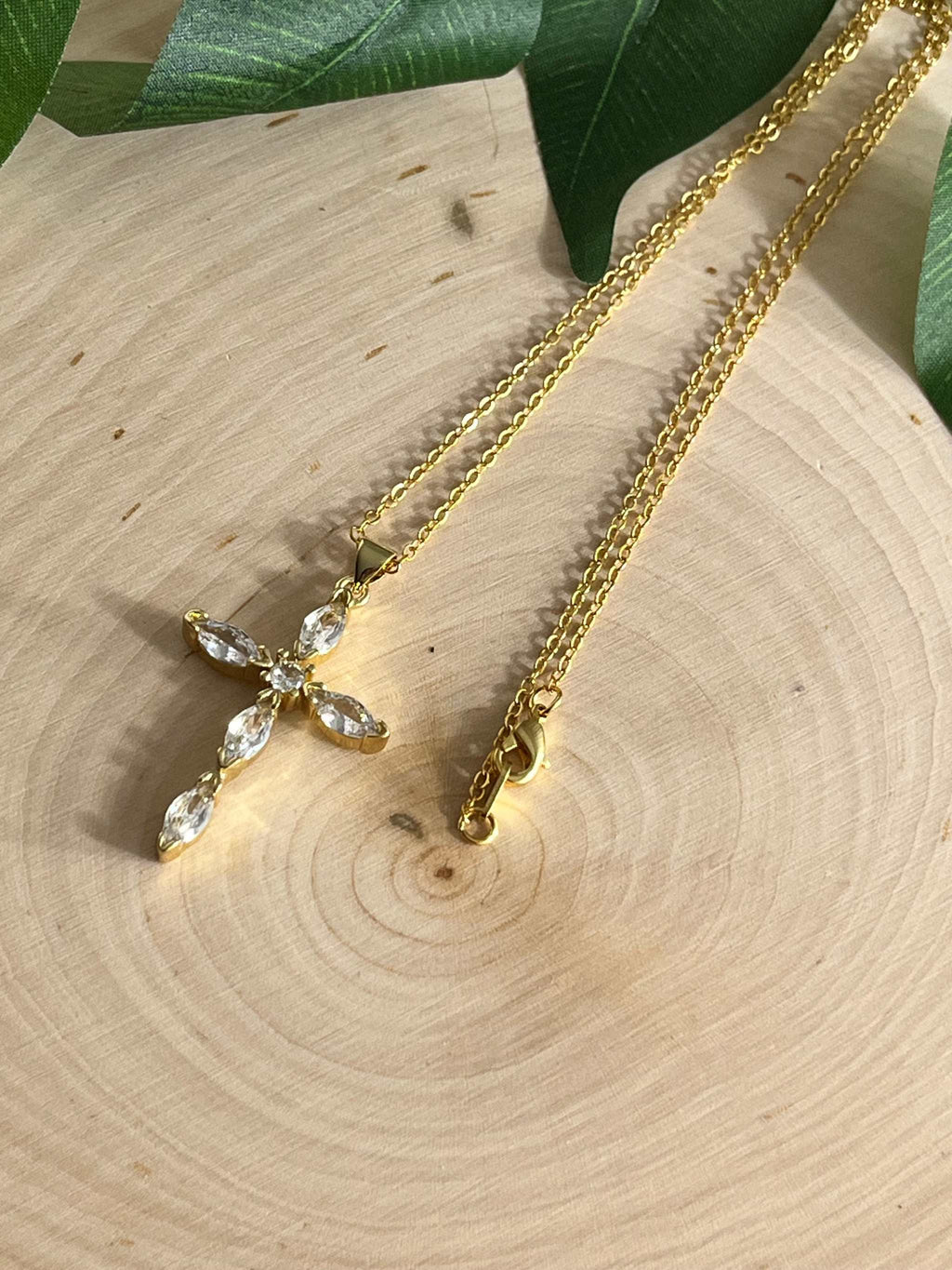 Gold cross pendant necklace with clear crystal cross and two chain views