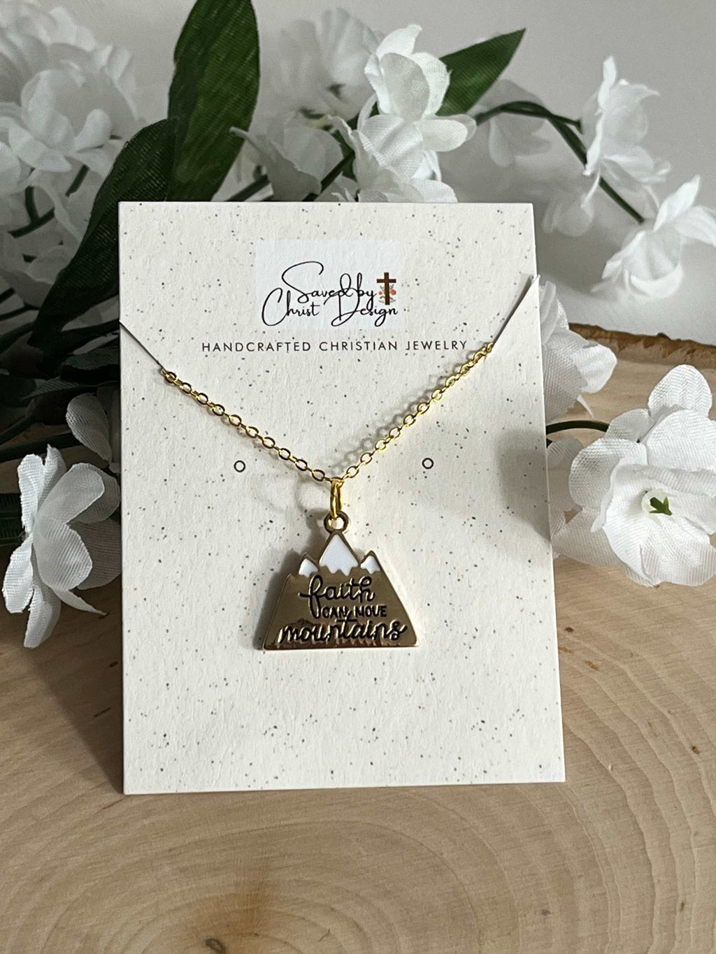 Gold chain necklace with heart pendant on jewelry card, scripture text visible
