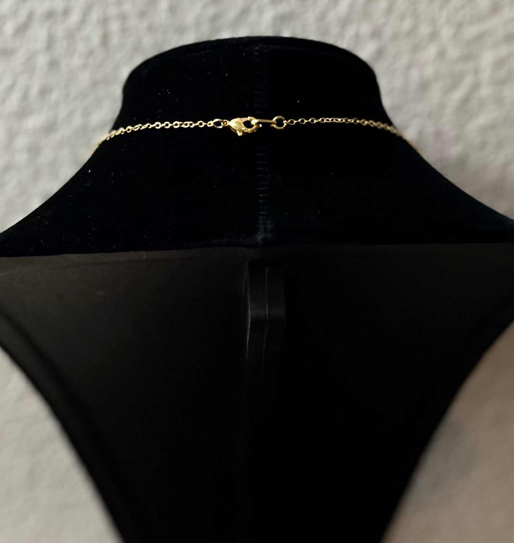 Gold necklace chain with clasp, shown from back on a display bust