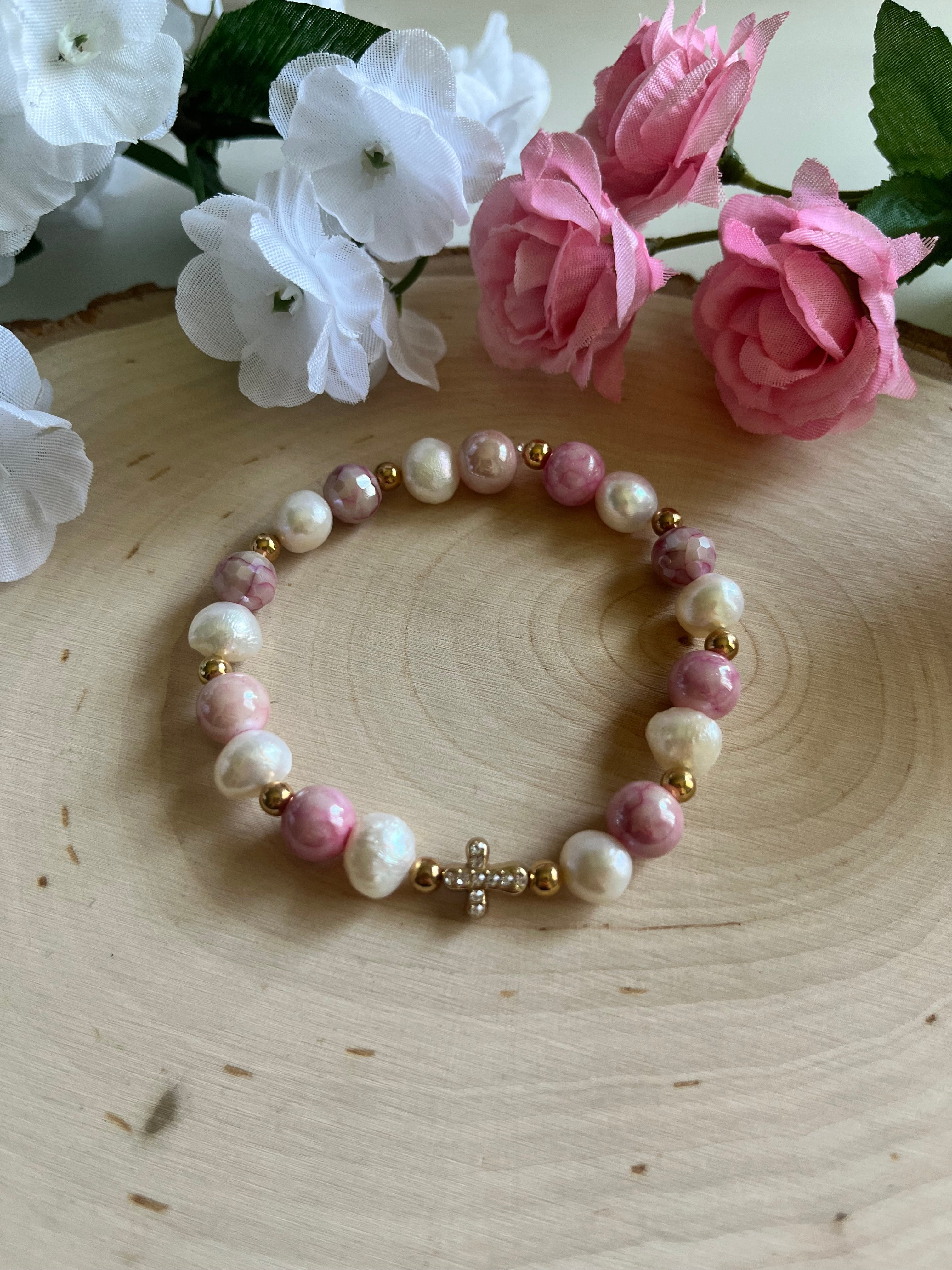 Pink and white pearl bead bracelet with gold cross charm at center