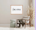 Wood-framed bible verse wall sign with floral border and 'Be still' scripture