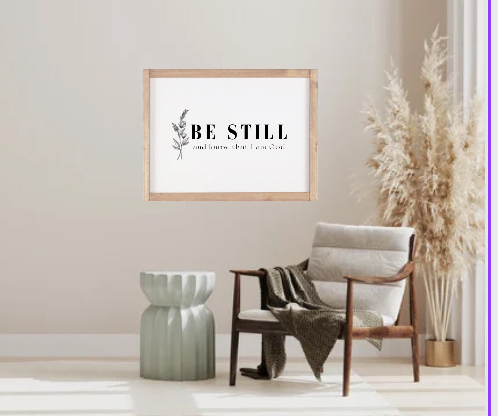 Wood-framed bible verse wall sign with floral border and 'Be still' scripture