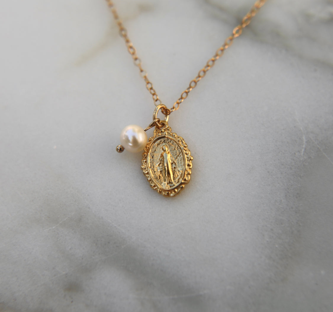 Gold-tone miraculous medal necklace with pearl bead and oval pendant on gold chain