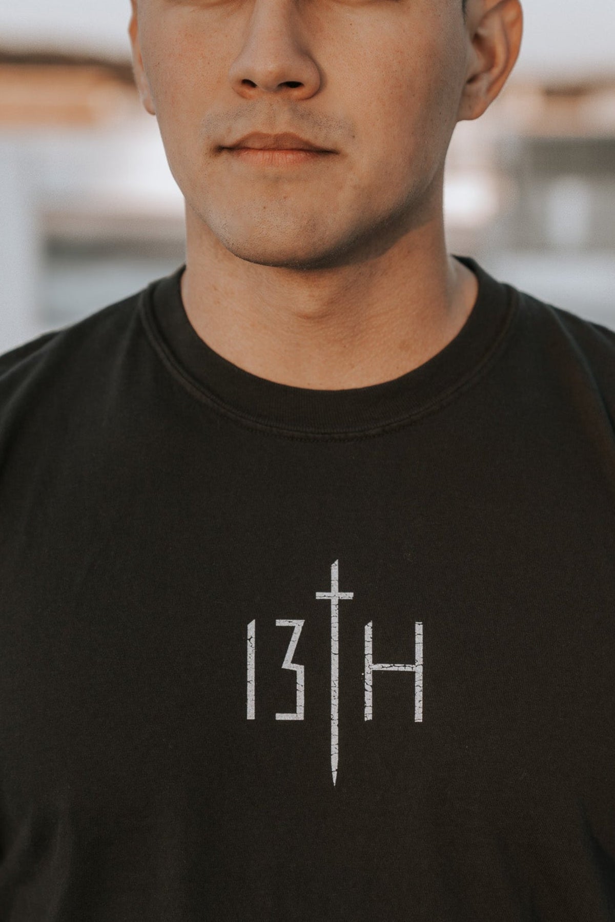 Black tee shirt front with white cross and '13TH' print