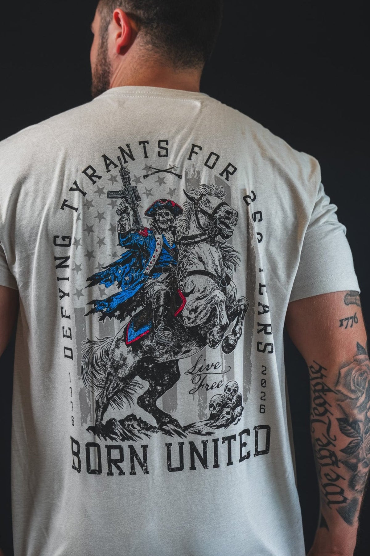 Light gray graphic back T-shirt with horse-and-rider design and “Born United” text
