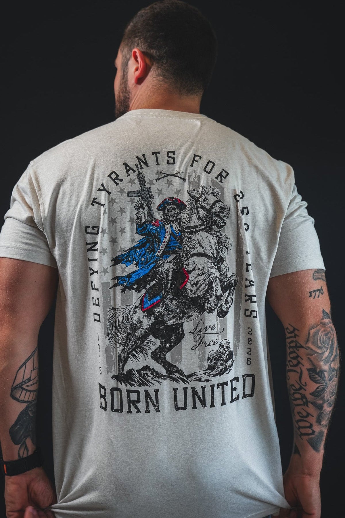 Light gray graphic back T-shirt with horse-and-rider illustration and “Born United” text