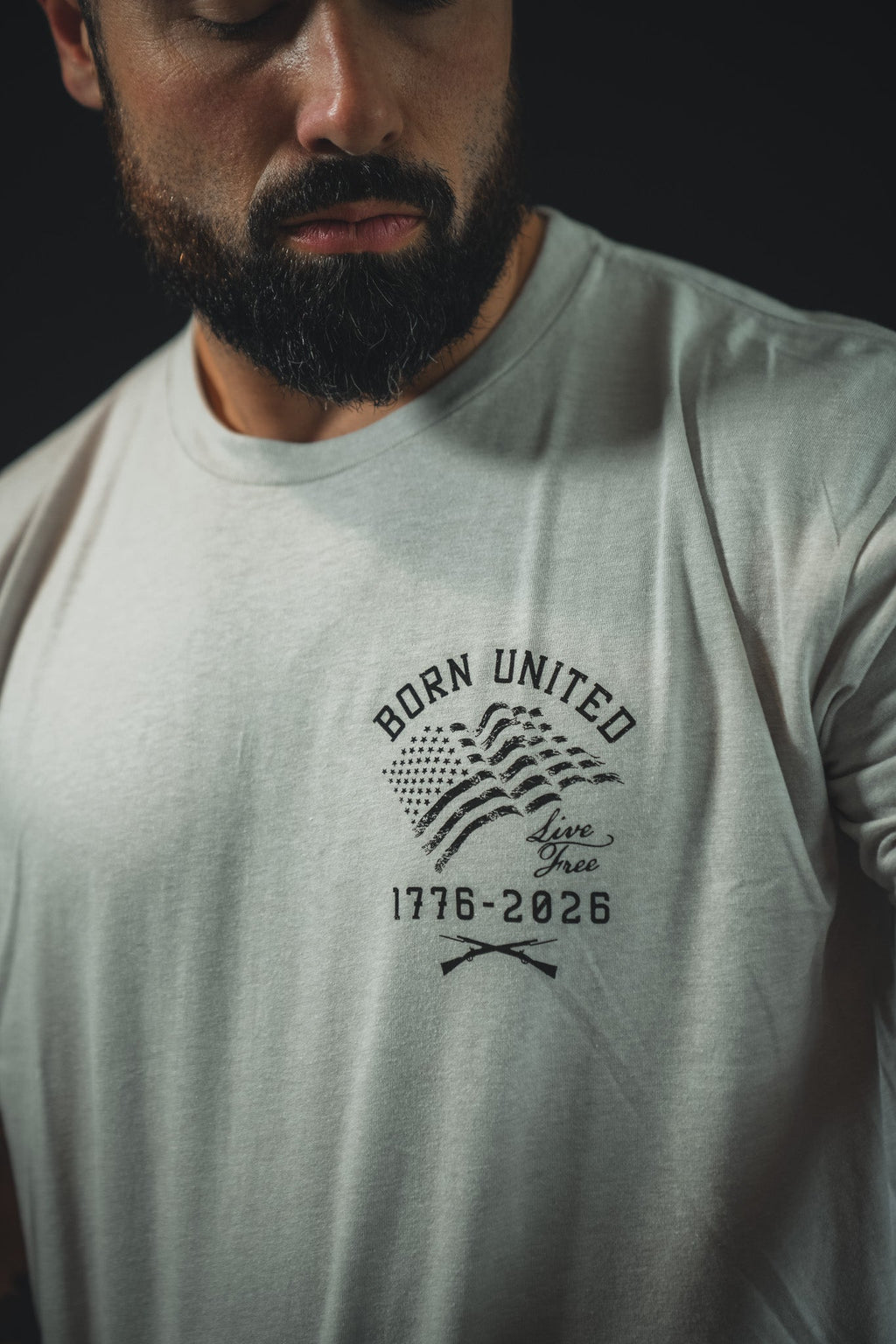 Light gray front T-shirt with centered “Born United” emblem and crossbones graphic