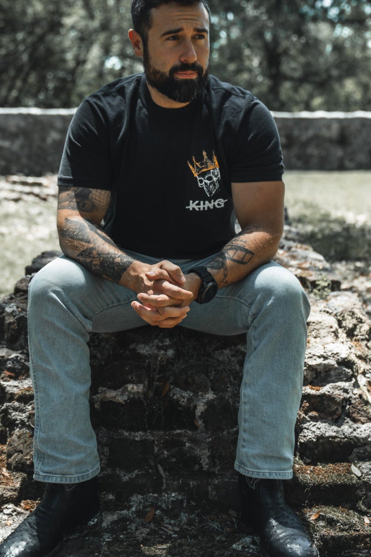 Black premium graphic tee with small chest logo and white text