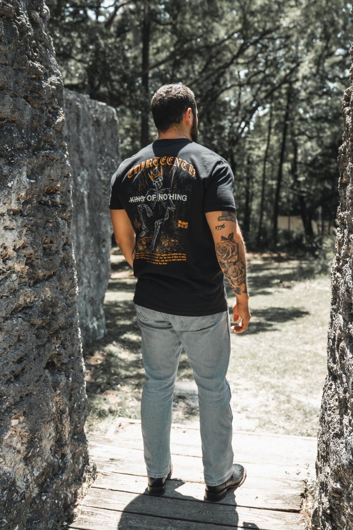 Black premium graphic tee with large back print in gold and white