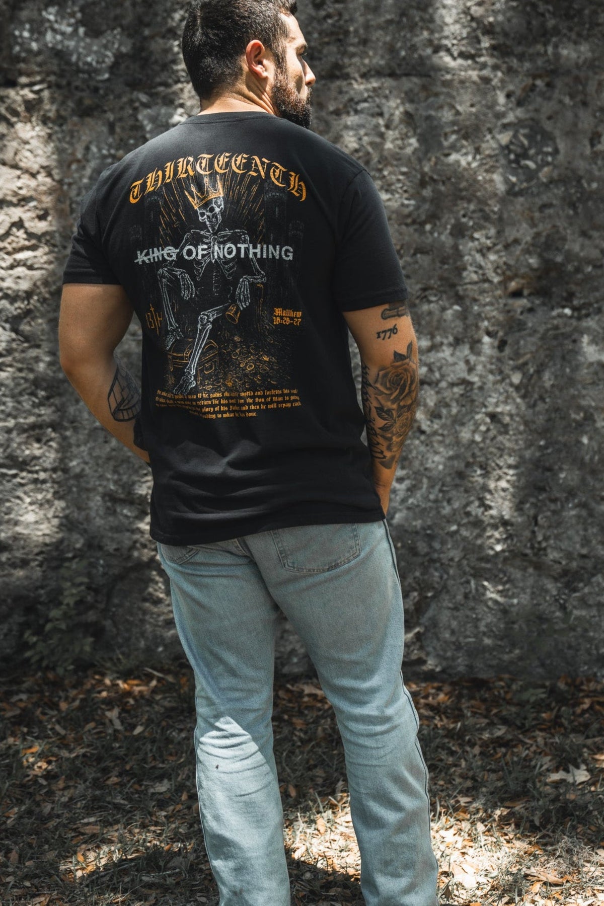 Black premium graphic tee with back text and gold-and-white artwork