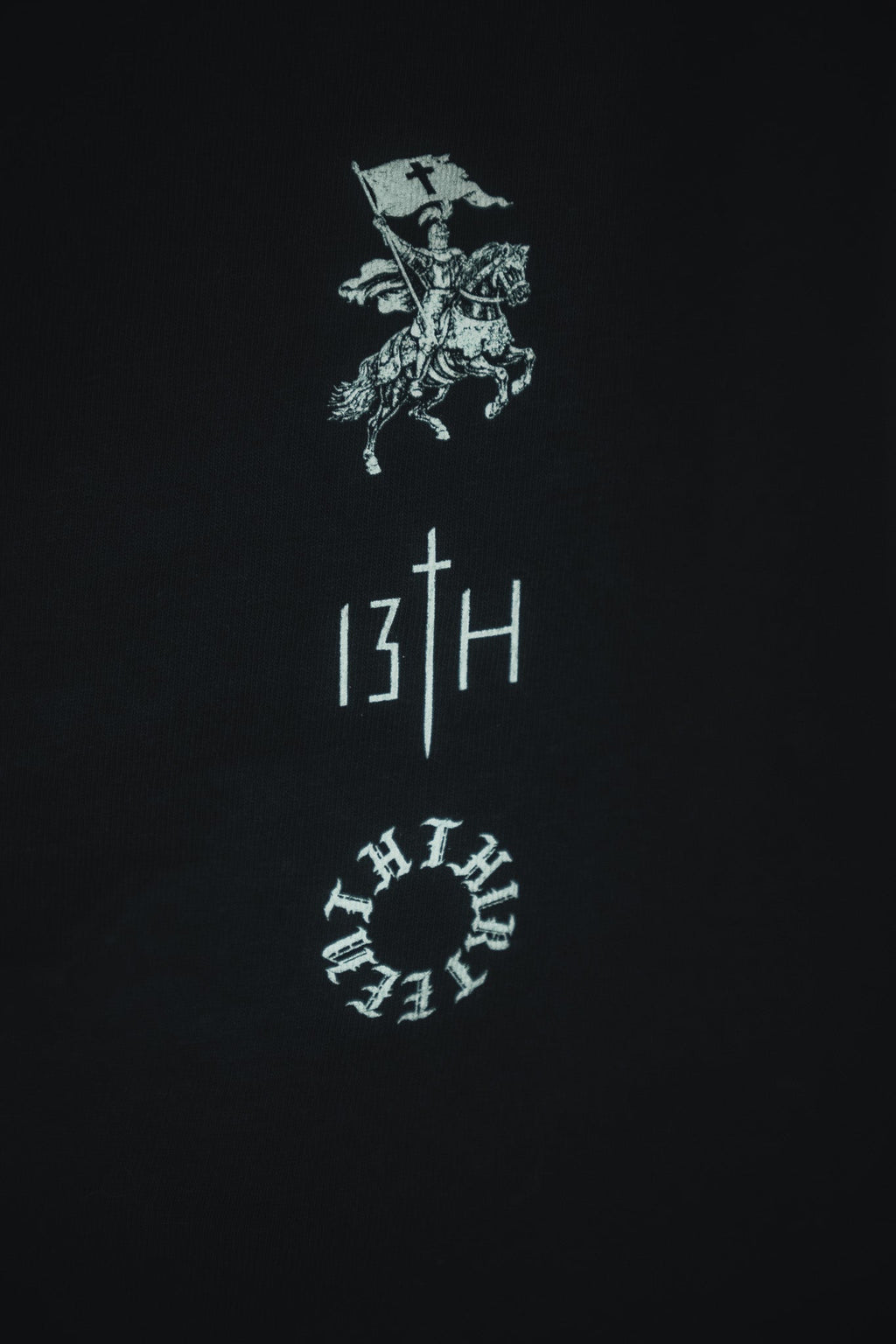 Black tee with white and red back emblem and vertical '13TH' graphic