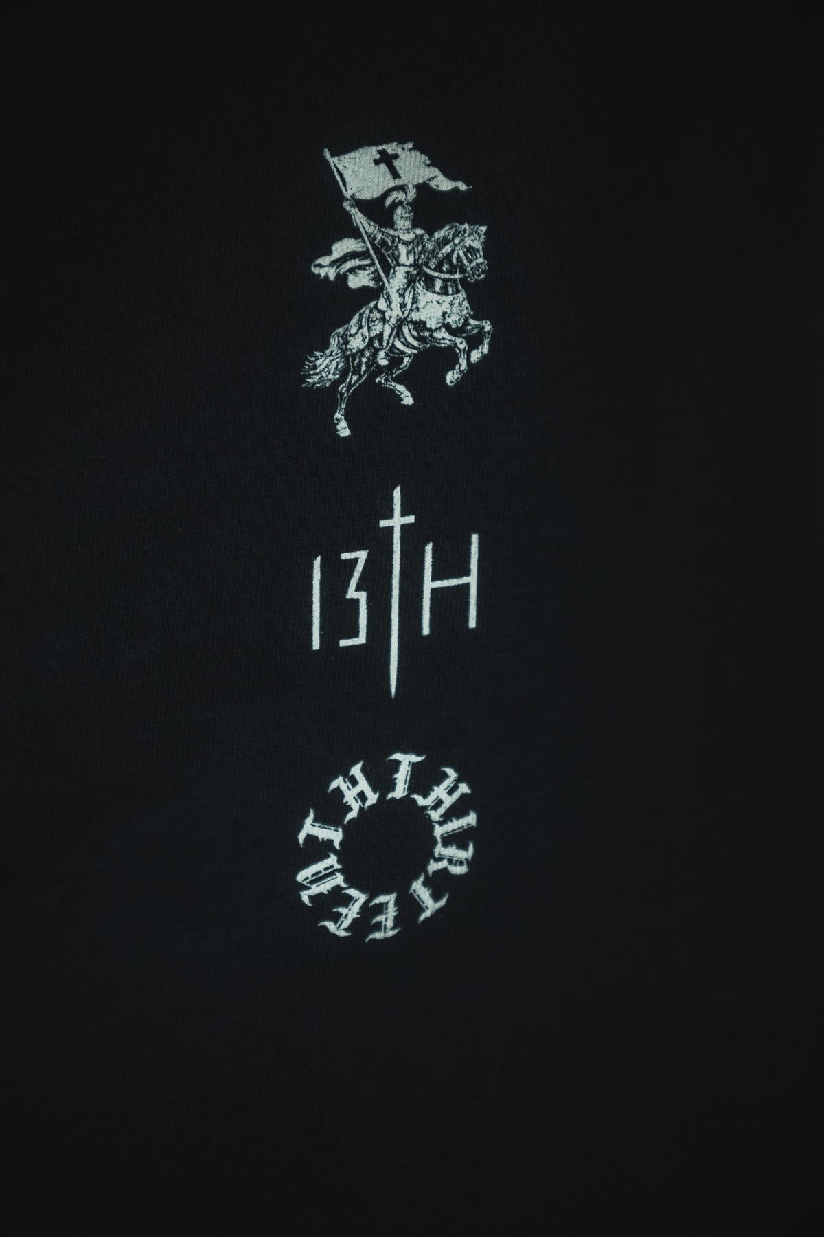 Black tee with white and red back emblem and vertical '13TH' graphic