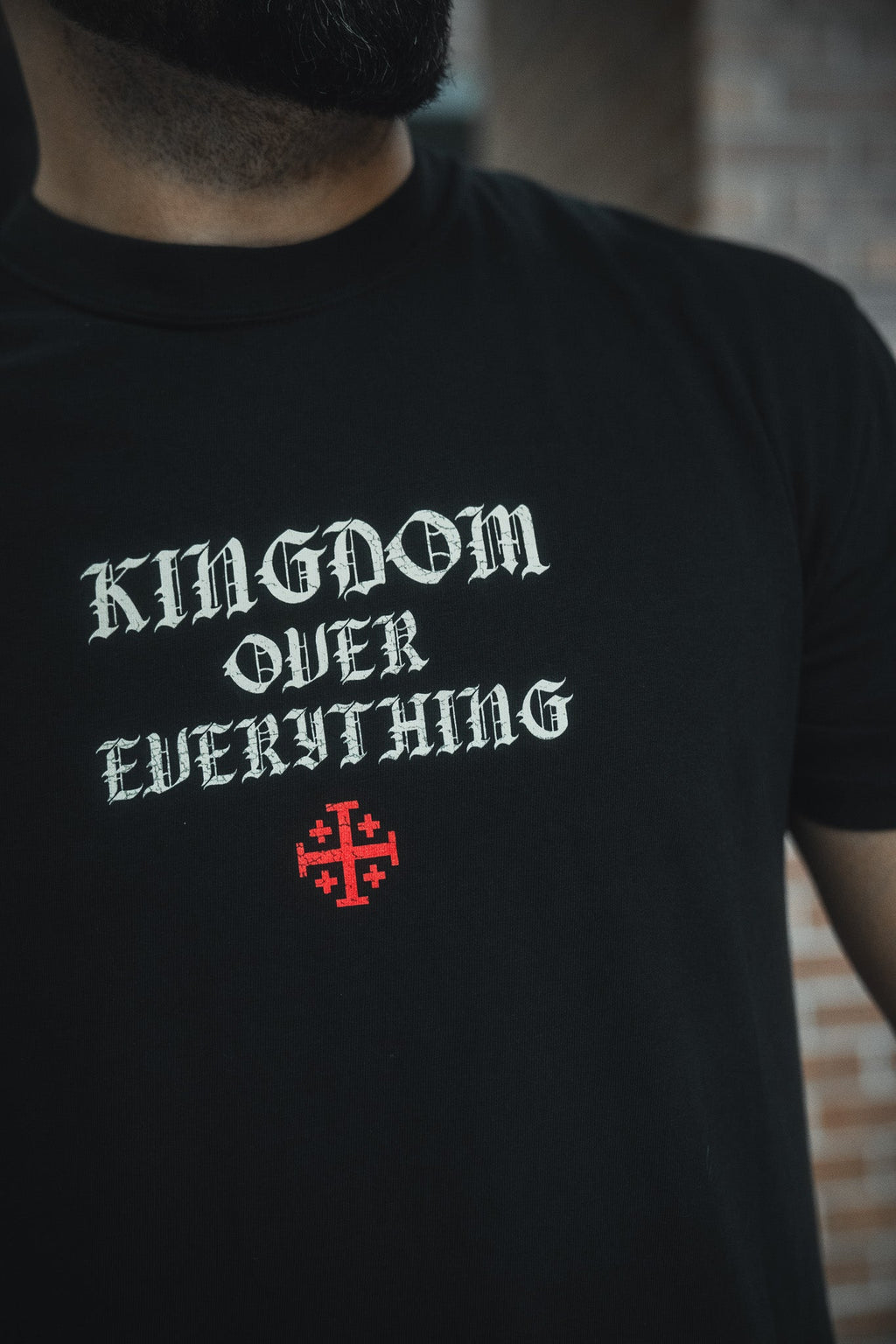 Black crew-neck tee with large back chest graphic and red cross details