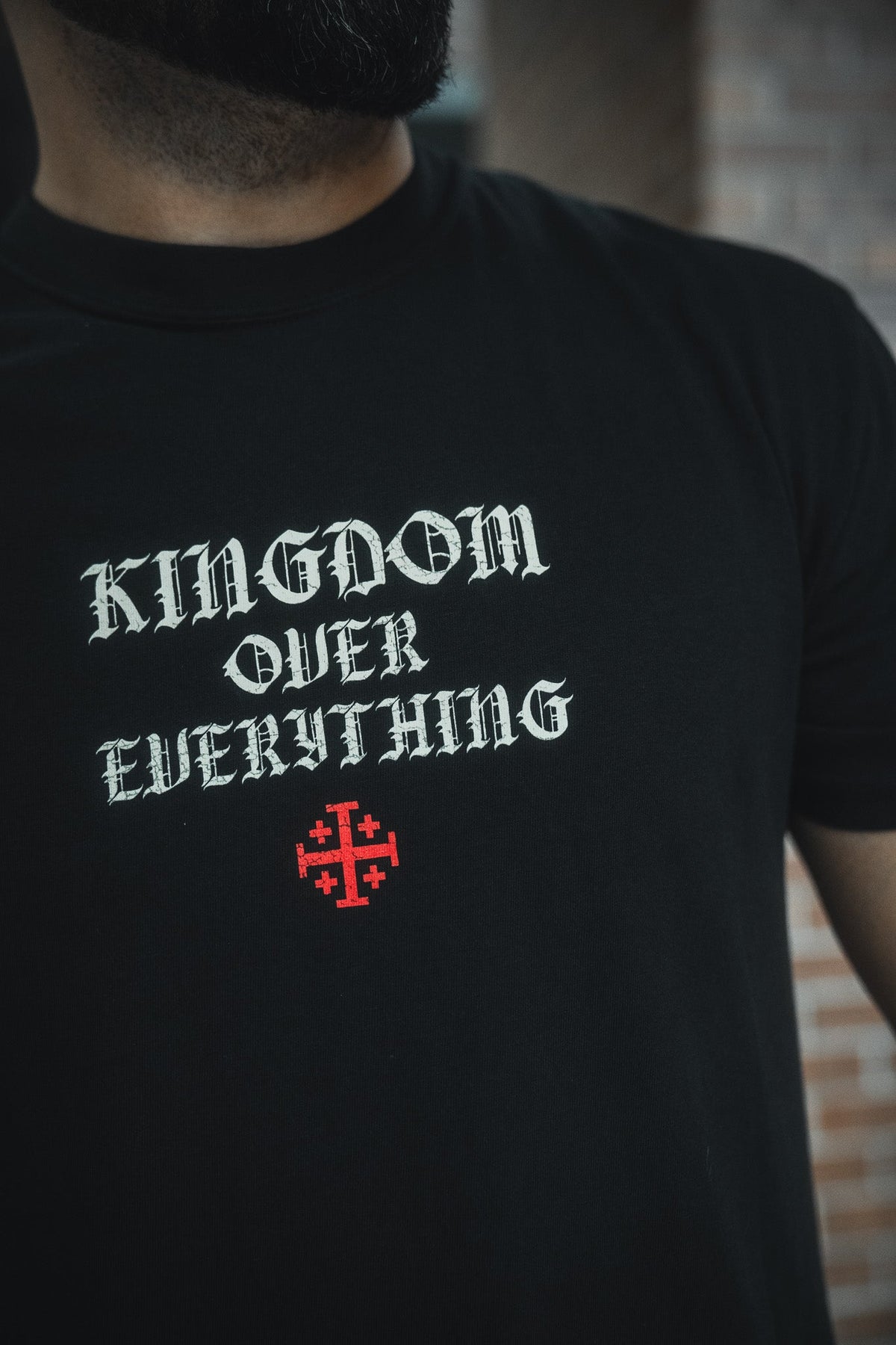 Black crew-neck tee with large back chest graphic and red cross details